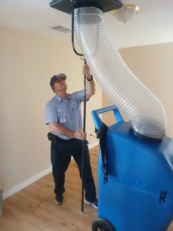 Furnace Tune-Up technician using HEPA equipment in Oak Hill